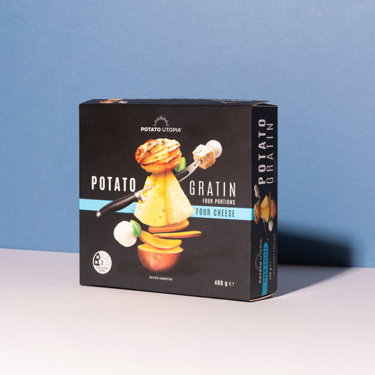 Box of Potato Utopia Four Cheese Gratin on a white surface with a blue background