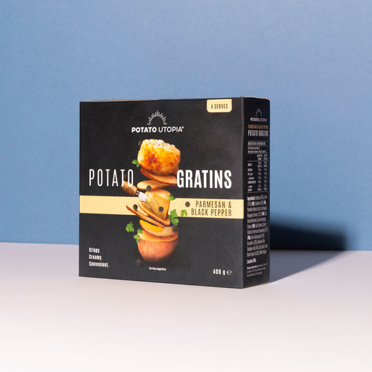 Box of Potato Utopia Potato Parmesan and Black Pepper Gratins on a white surface with a blue background