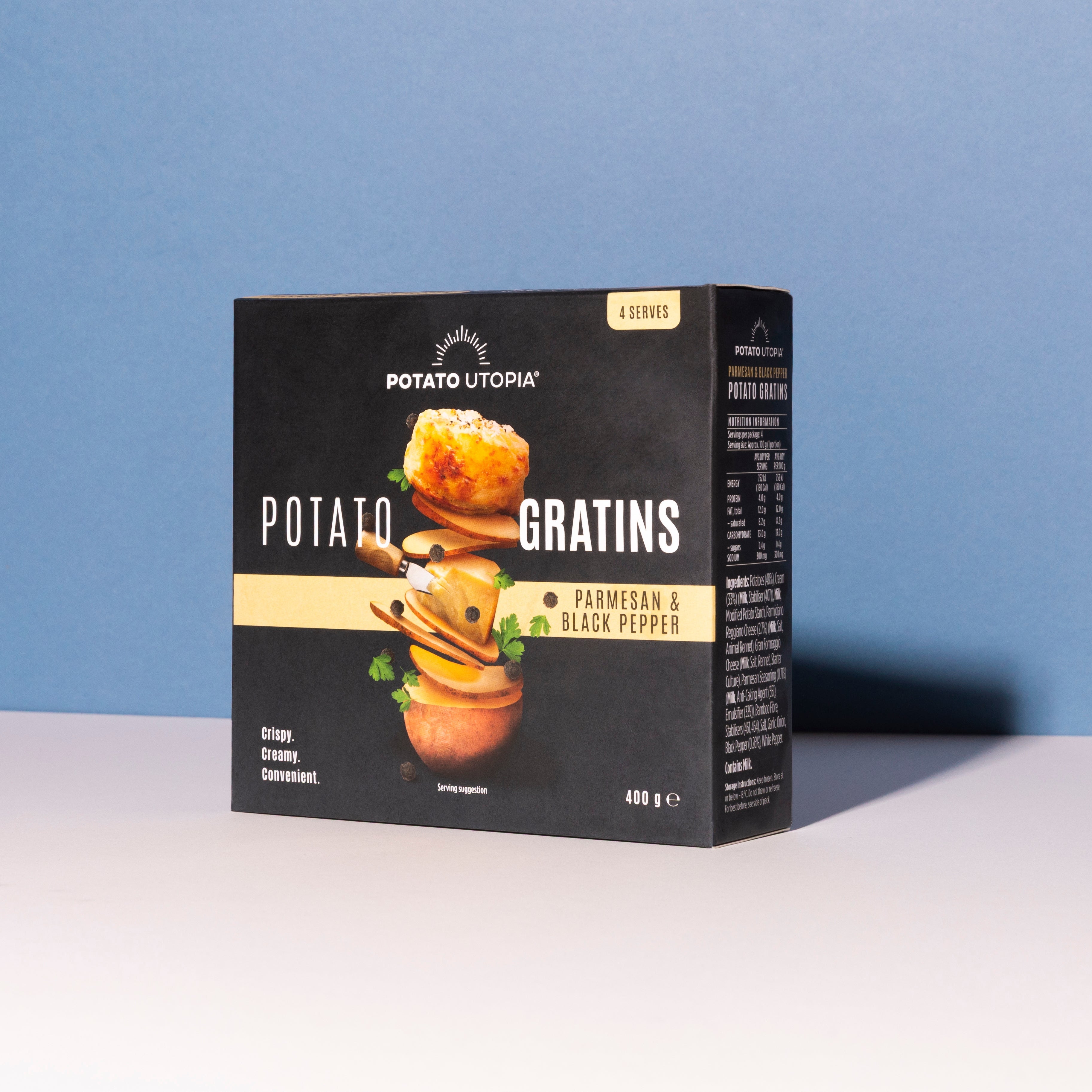 Box of Potato Utopia Potato Parmesan and Black Pepper Gratins on a white surface with a blue background