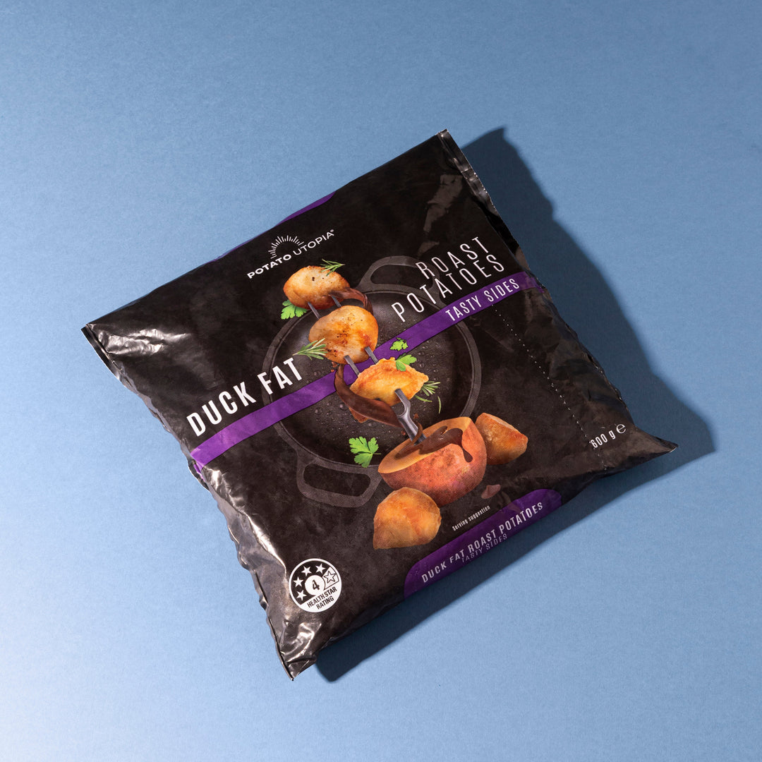 Packaged potato utopia duck fat roast potatoes  product on a blue background